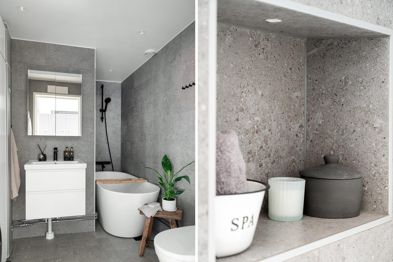 Påkostat badrum med badkar, tvättmaskin och torktumlare